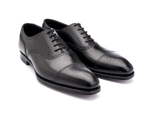 Front angle view of Crockett & Jones Selborne half brogue oxford shoes in black calf