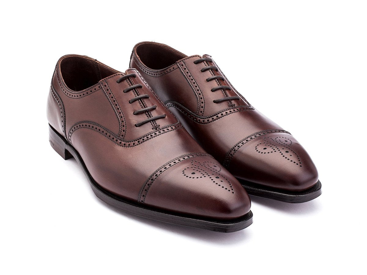 Front angle view of Crockett & Jones Selborne half brogue oxford shoes in chestnut antique calf