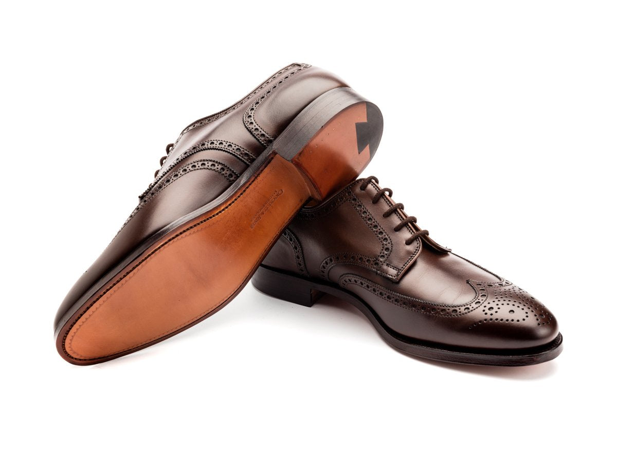 Leather sole of Crockett & Jones Swansea wingtip full brogue derby shoes in dark brown burnished calf