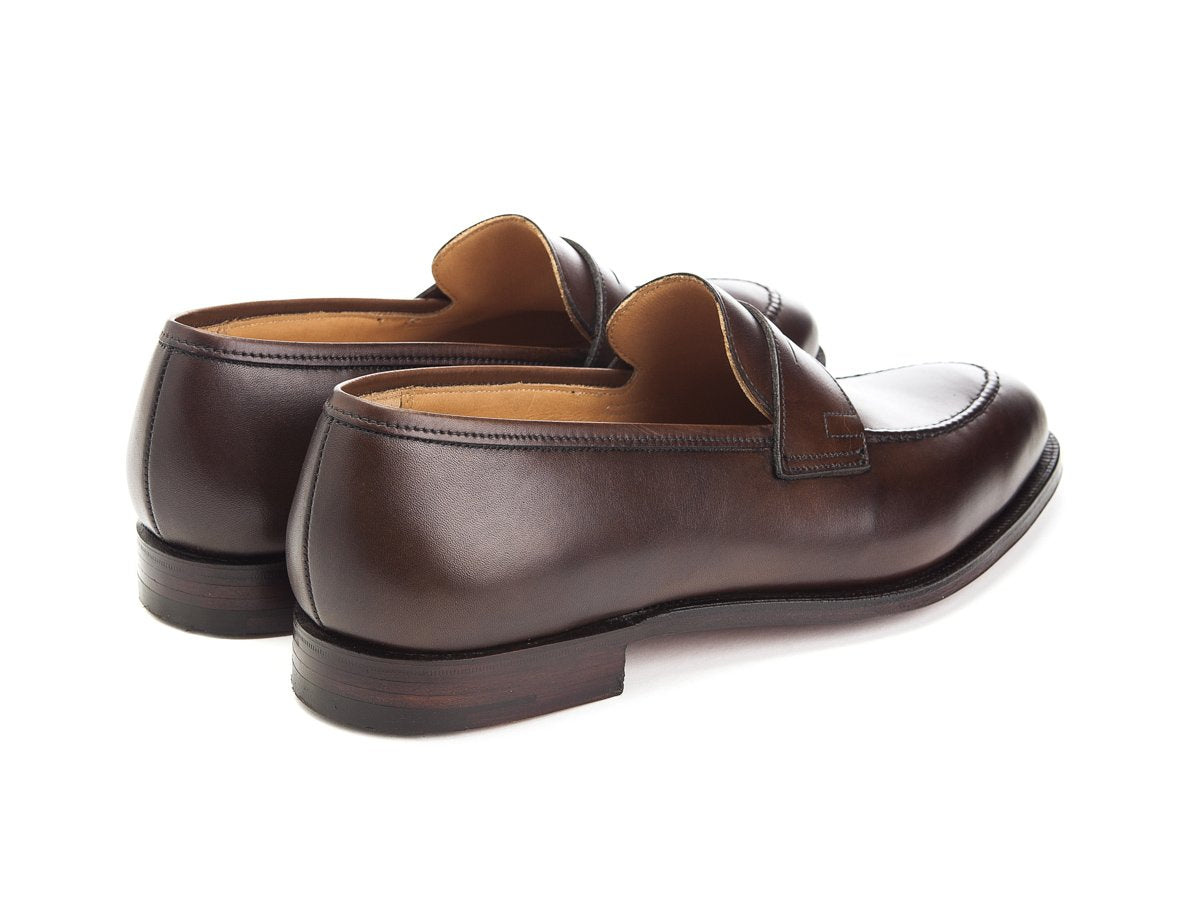 Back angle view of Crockett & Jones Sydney penny loafers in dark brown burnished calf
