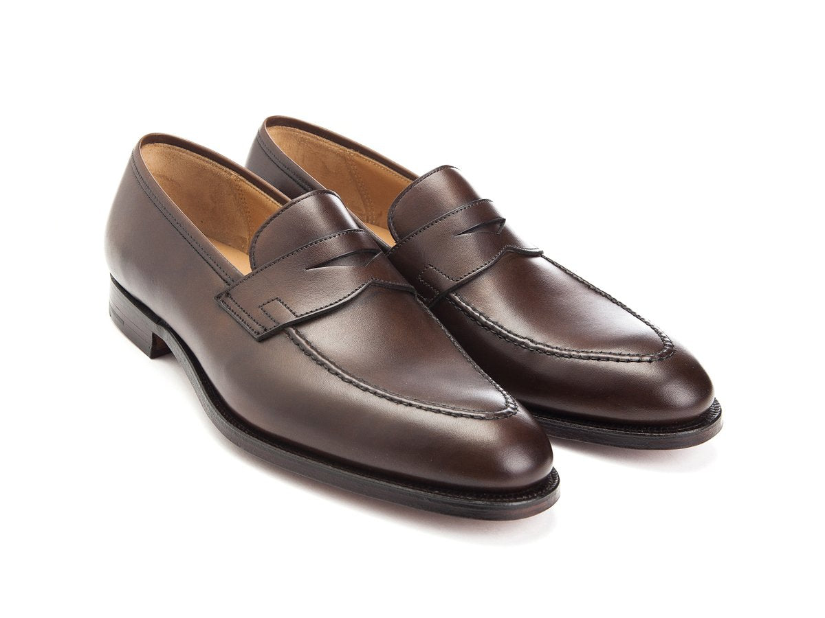 Front angle view of Crockett & Jones Sydney penny loafers in dark brown burnished calf