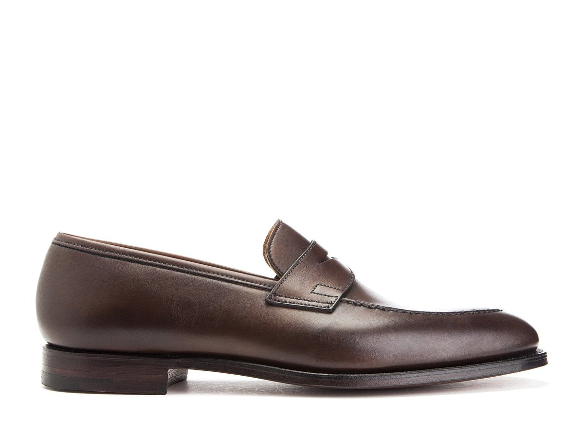 Side view of Crockett & Jones Sydney penny loafers in dark brown burnished calf
