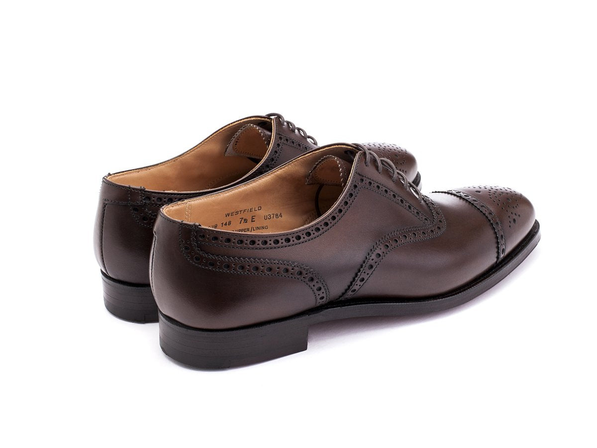 Back angle view of Crockett & Jones Westfield half brogue oxford shoes in dark brown burnished calf
