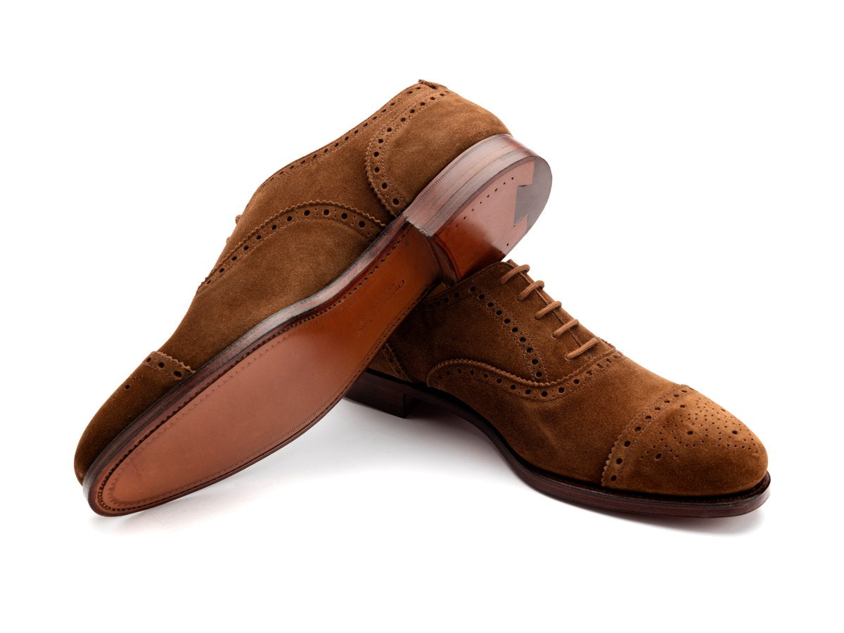 Leather sole of Crockett & Jones Westfield half brogue oxford shoes in tobacco suede