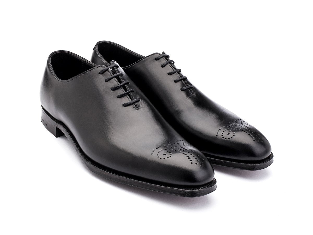 Front angle view of Crockett & Jones Weymouth wholecut medallion oxford shoes in black calf