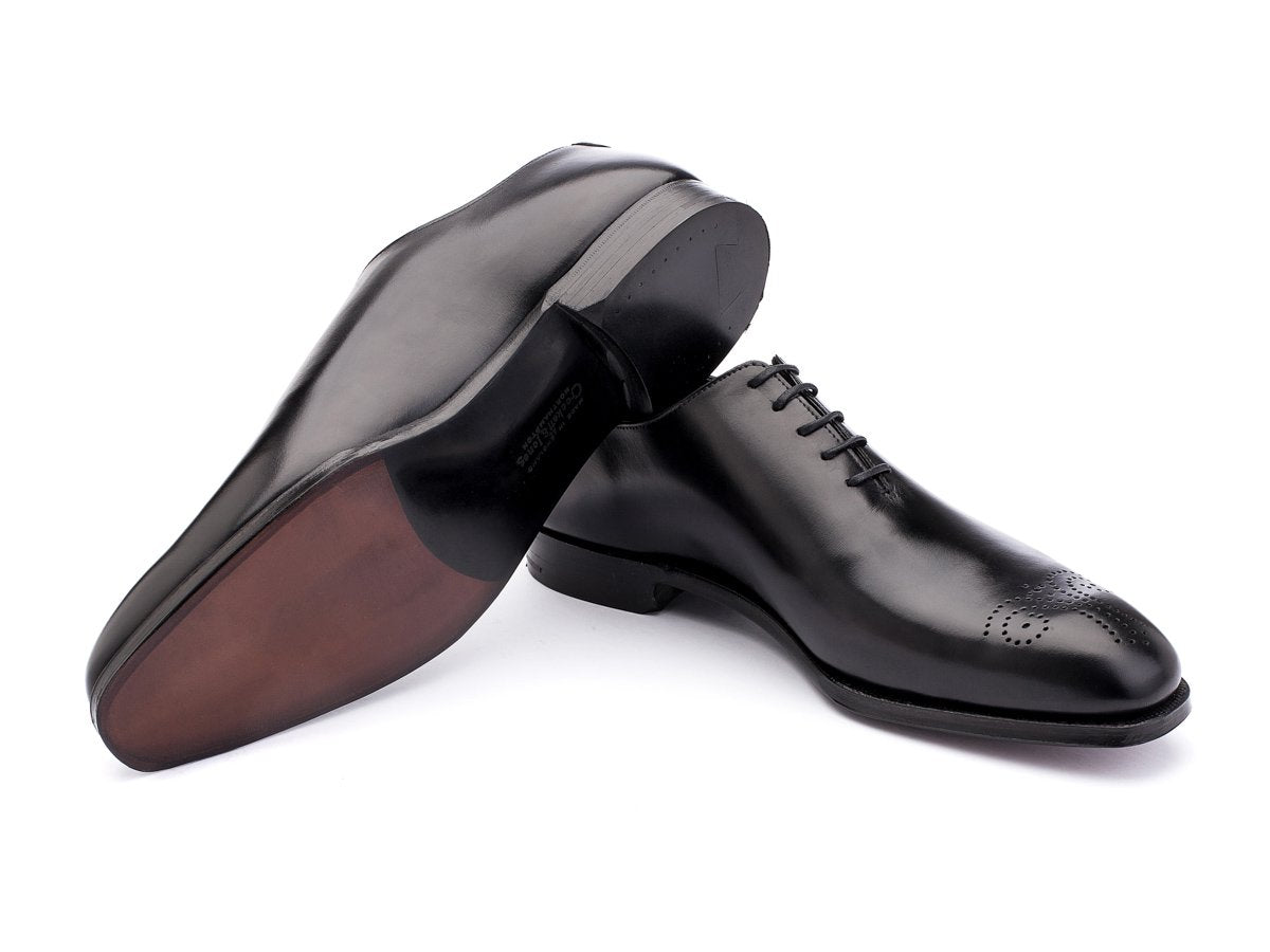 Leather sole of Crockett & Jones Weymouth wholecut medallion oxford shoes in black calf