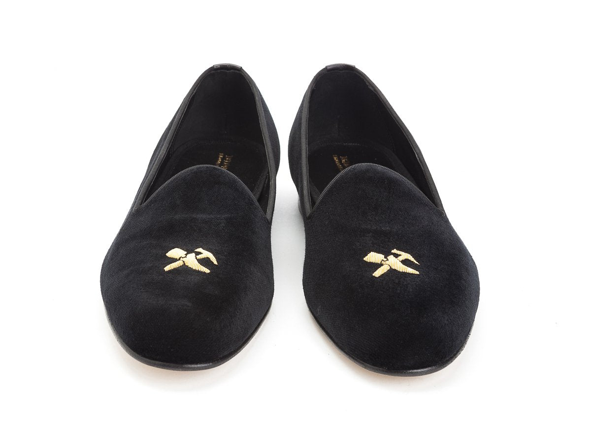 Front view of Edward Green Albert slippers in black velvet with hand embroidered gold Double Monk logo on toe