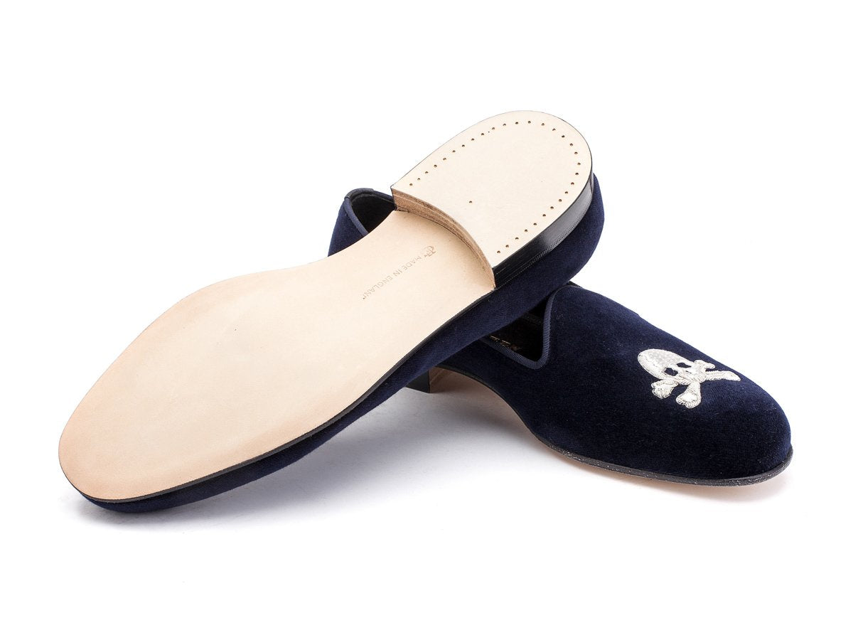 Leather sole of F width Edward Green Albert slippers in navy velvet with hand embroidered silver skull and crossbones motif on toe