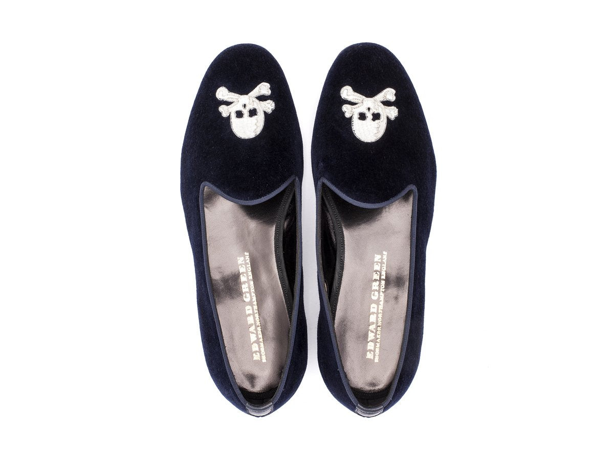 Top view of F width Edward Green Albert slippers in navy velvet with hand embroidered silver skull and crossbones motif on toe