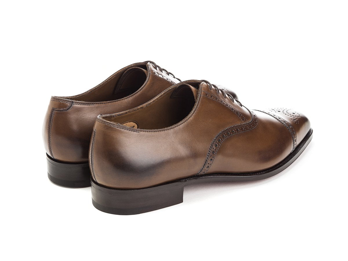 Back angle view of Edward Green Asquith half brogue oxford shoes in dark oak antique calf