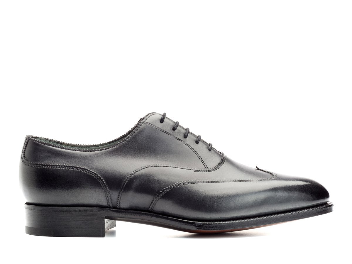 Side view of Edward Green Beaulieu austerity wingtip brogue oxford shoes in midnight blue antique calf