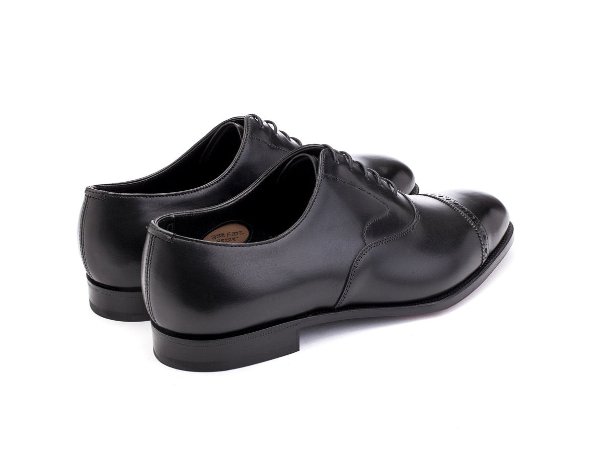 Back angle view of F width Edward Green Berkeley quarter brogue oxford shoes in black calf