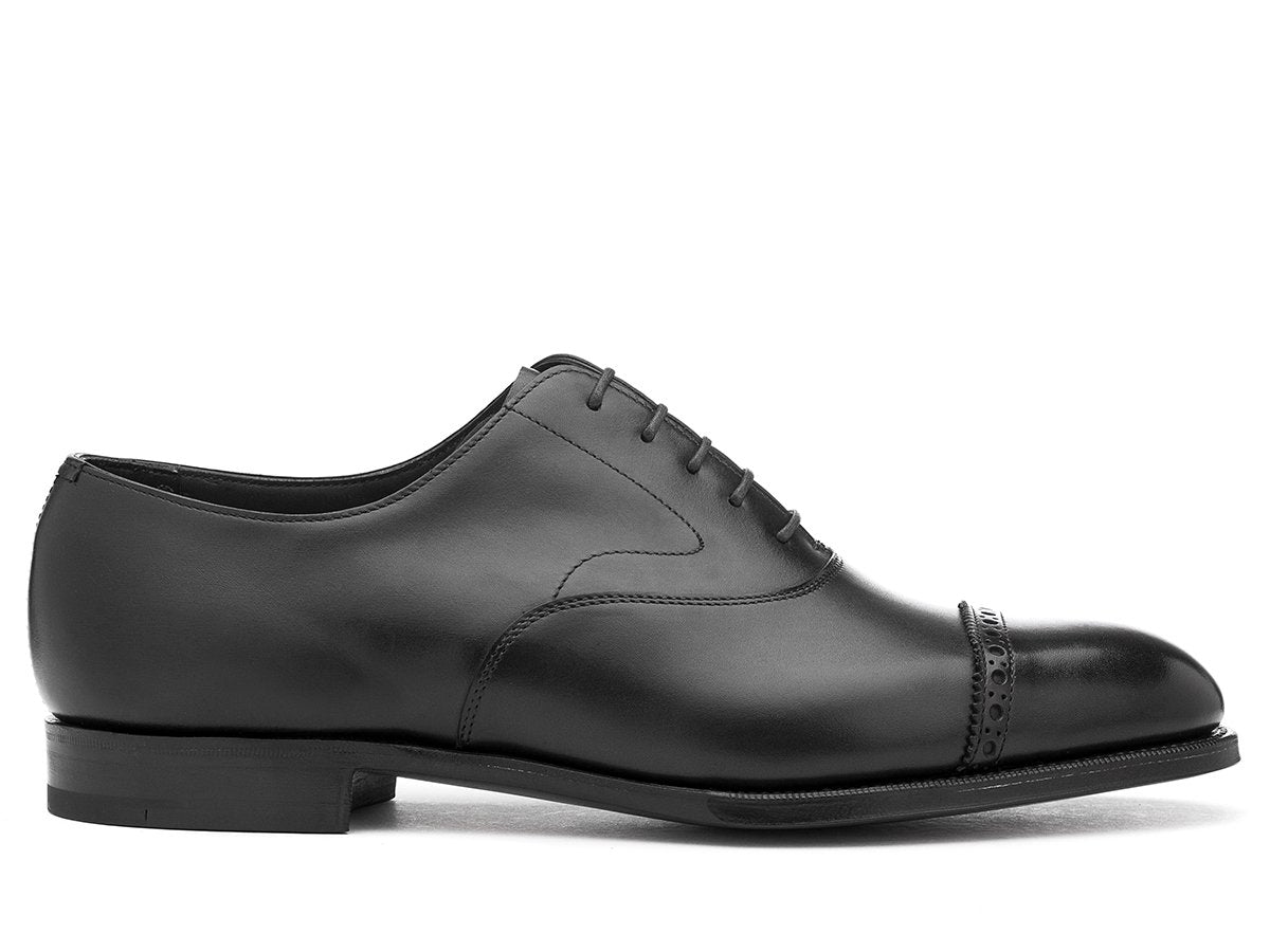 Side view of F width Edward Green Berkeley quarter brogue oxford shoes in black calf
