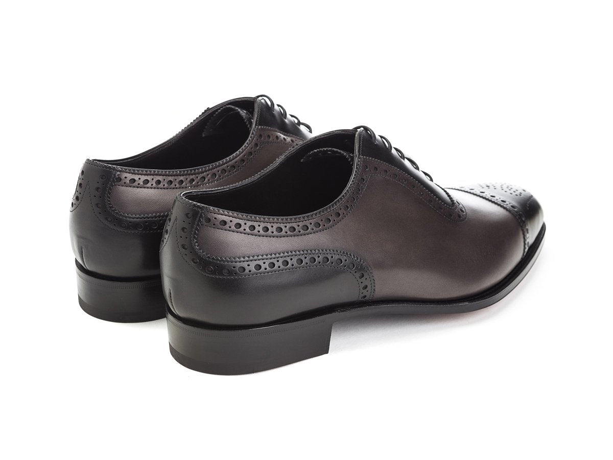 Back angle view of Edward Green Canterbury adelaide brogue oxford shoes in black and cloud antique calf