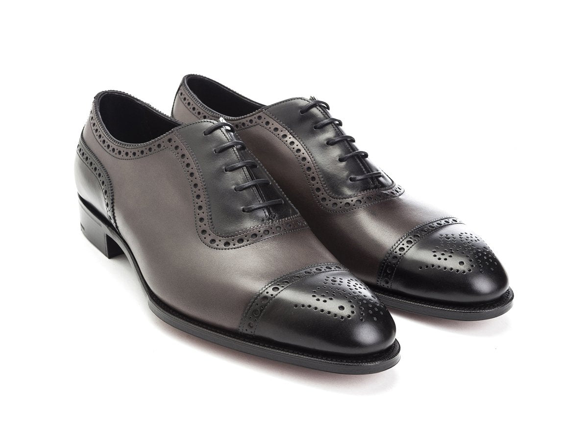 Front angle view of Edward Green Canterbury adelaide brogue oxford shoes in black and cloud antique calf