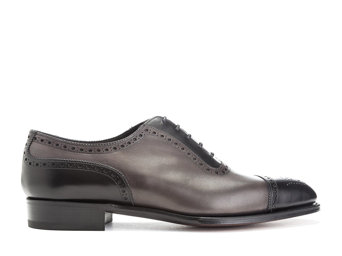 Side view of Edward Green Canterbury adelaide brogue oxford shoes in black and cloud antique calf