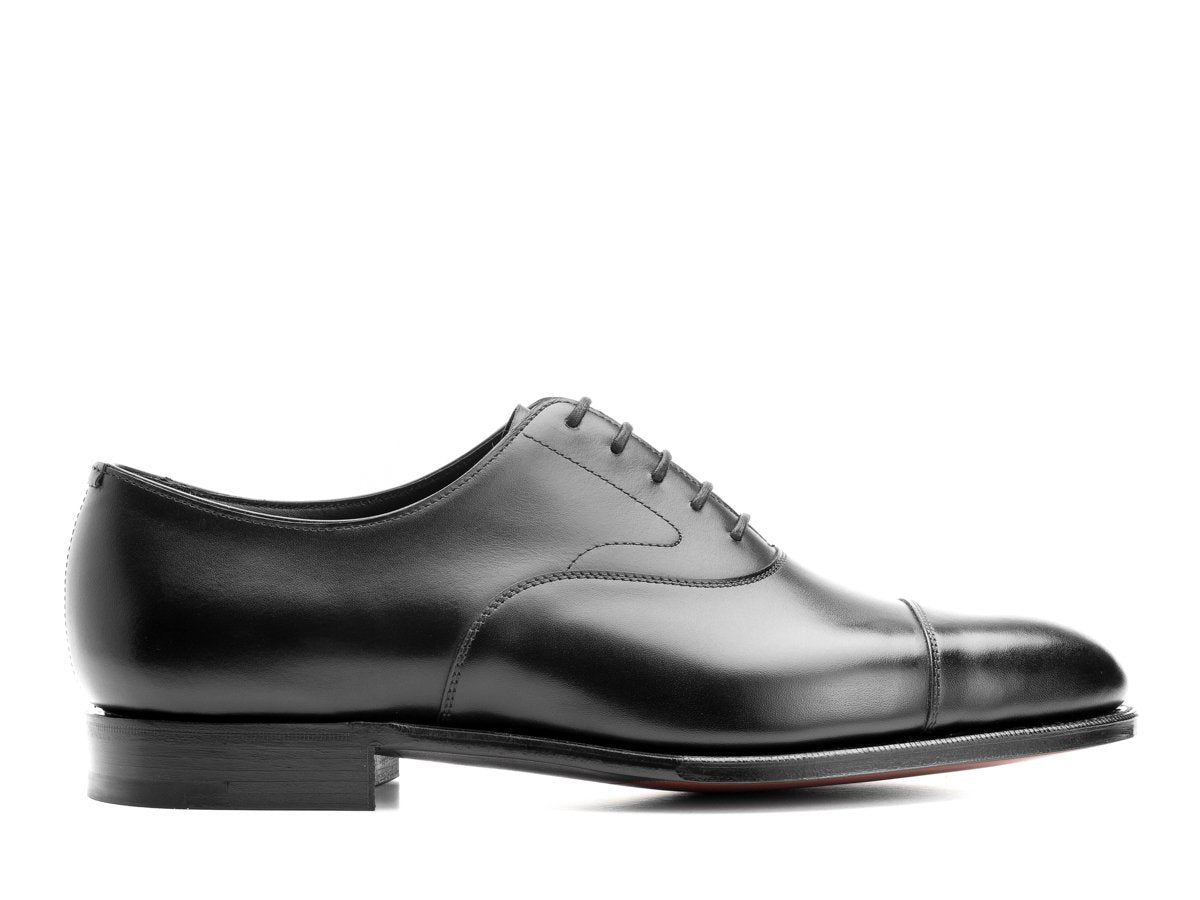 Side view of D width Edward Green Chelsea 202 plain captoe oxford shoes in black calf