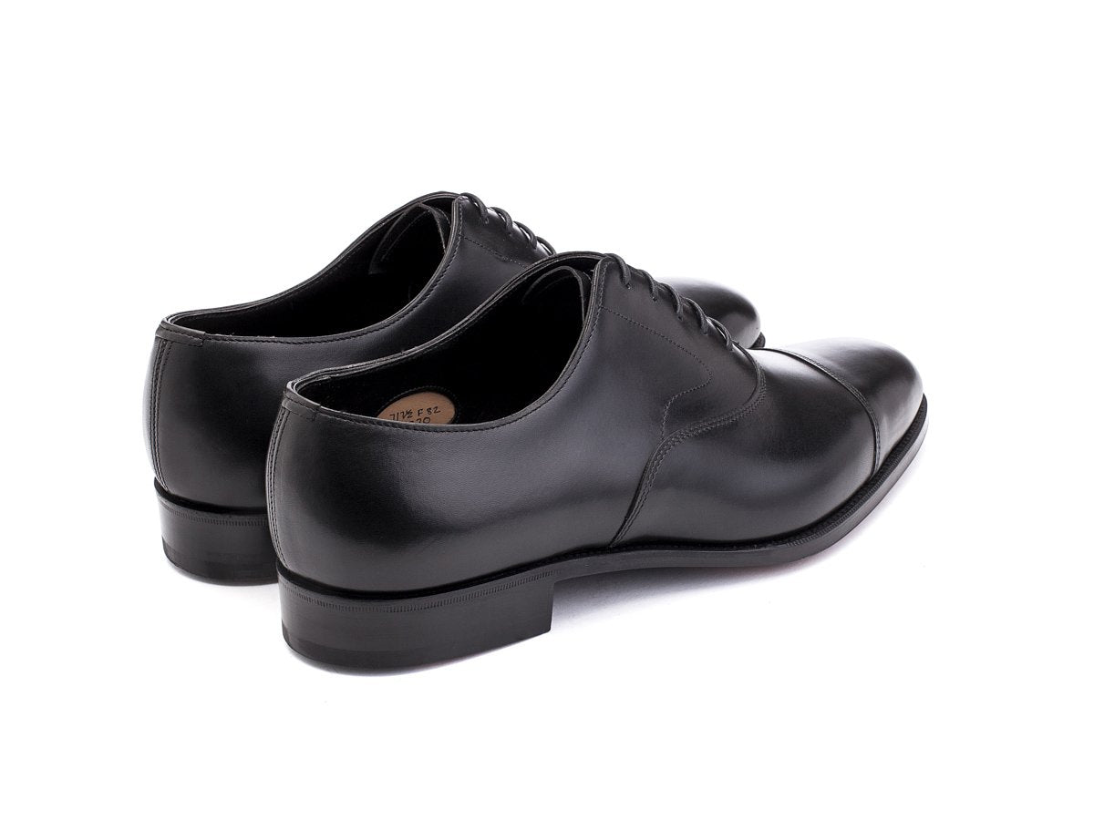 Back angle view of Edward Green Chelsea plain captoe oxford shoes in black calf