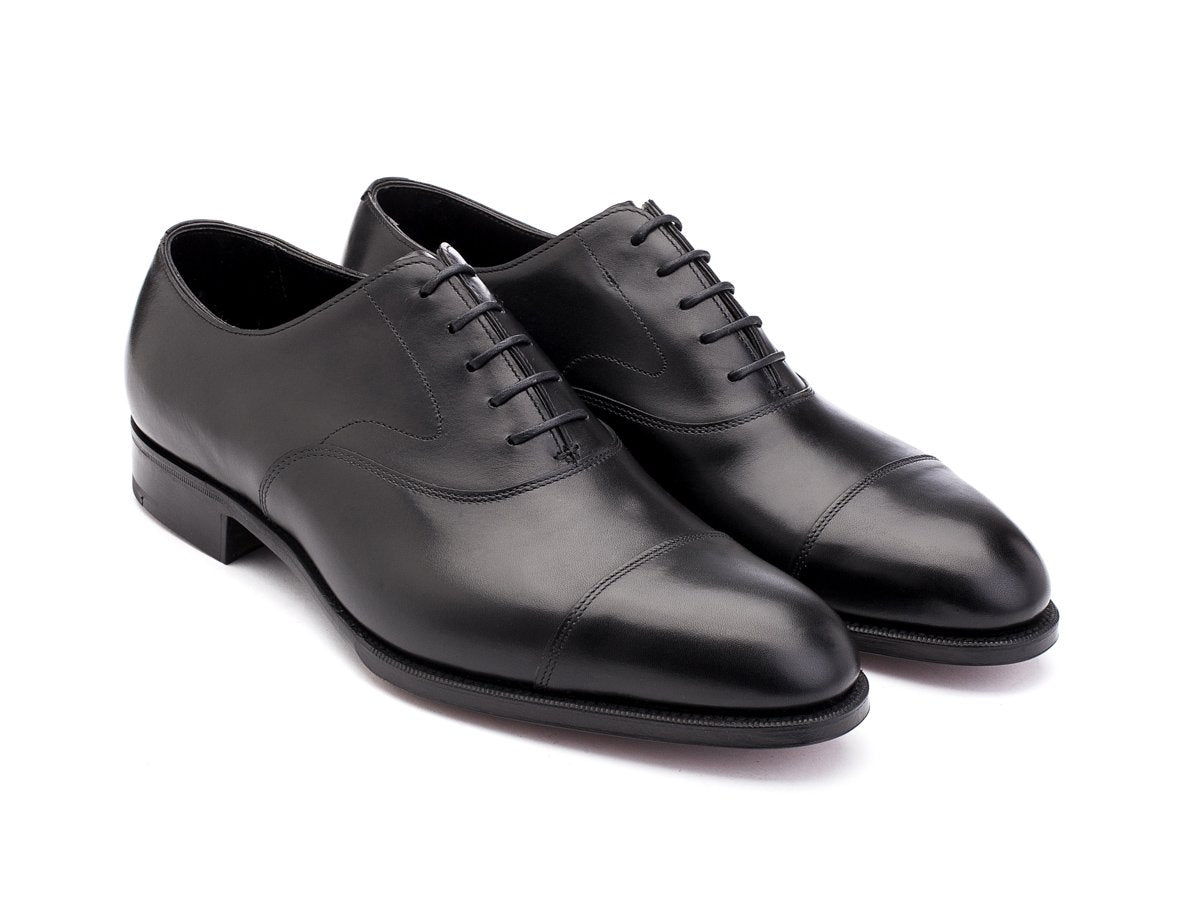 Front angle view of F width Edward Green Chelsea plain captoe oxford shoes in black calf