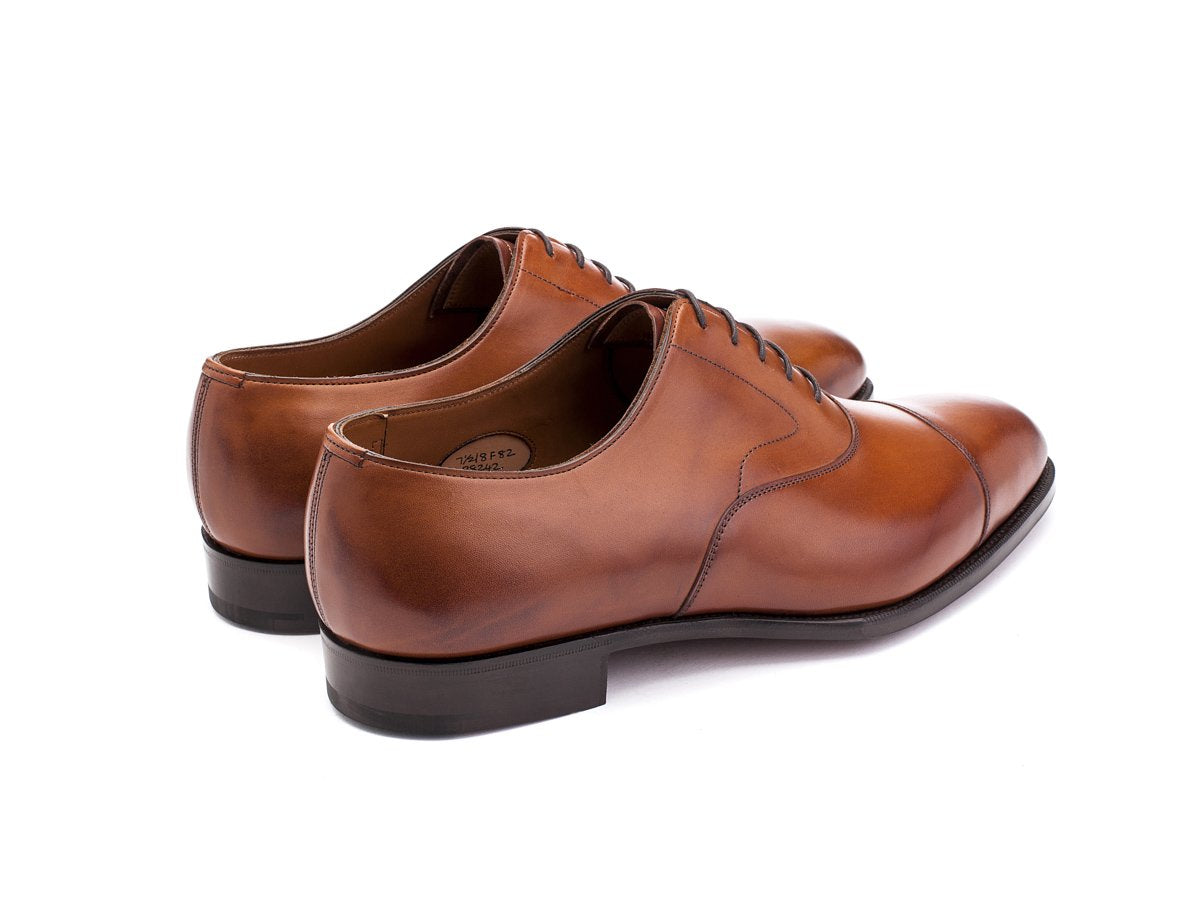 Back angle view of F width Edward Green Chelsea plain captoe oxford shoes in chestnut antique calf