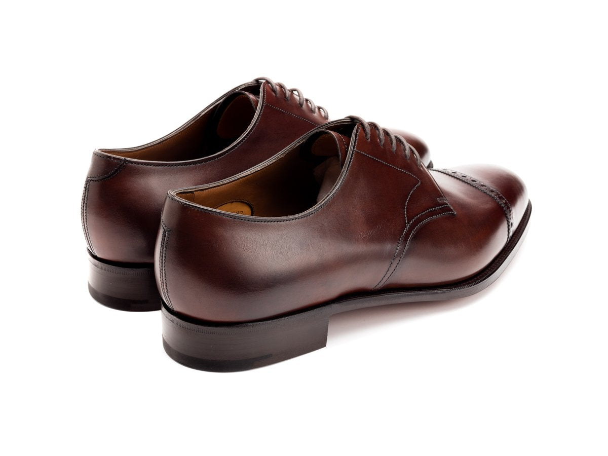 Back angle view of Edward Green Elmsley quarter brogue derby shoes in dark oak antique calf