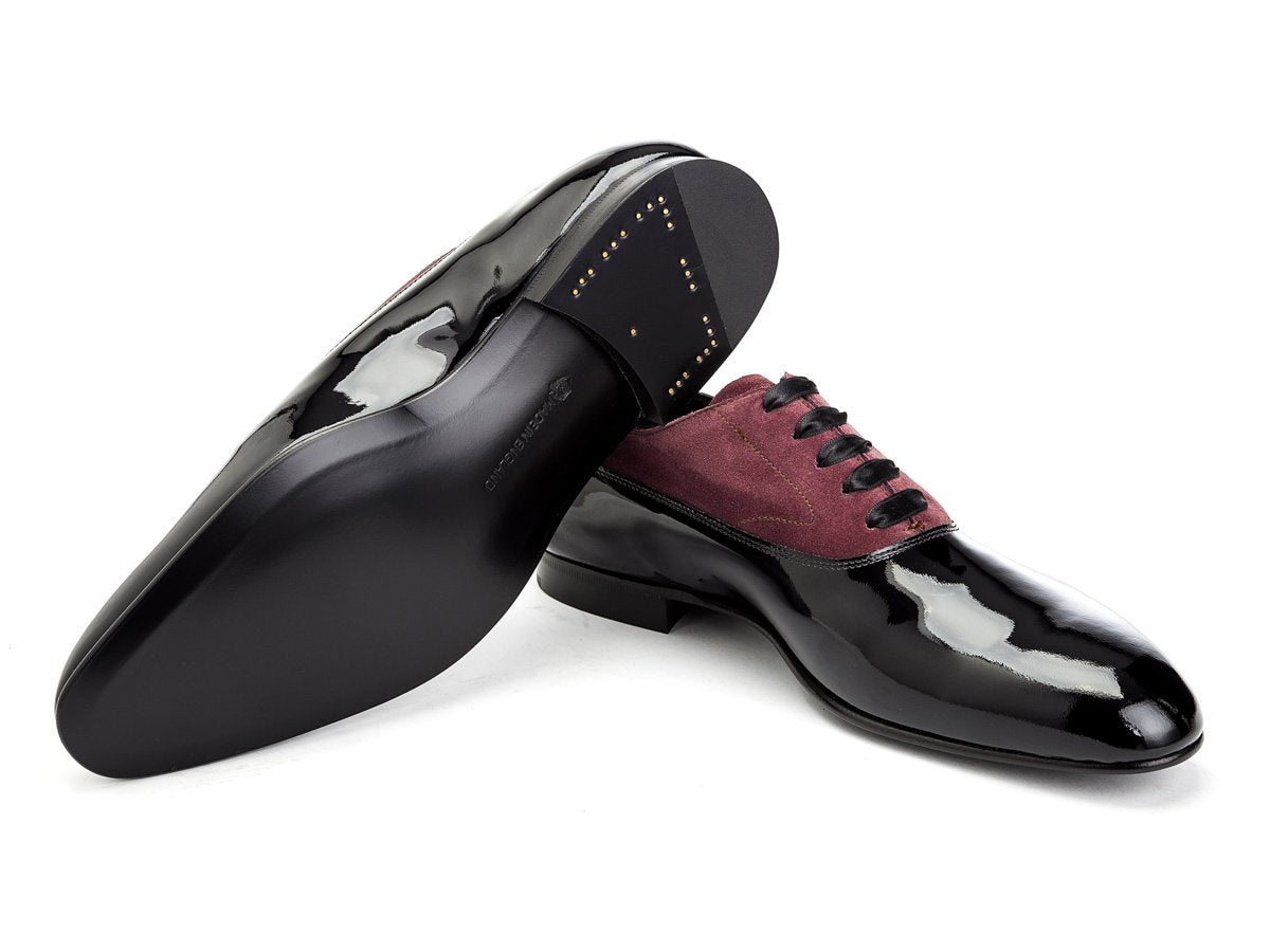 Leather sole of Edward Green Ifford plain toe balmoral oxford shoes in black patent and claret suede