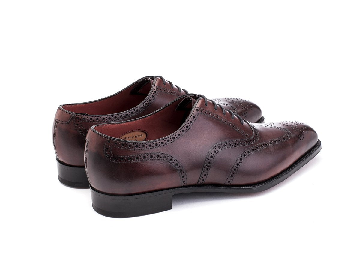 Back angle view of Edward Green Inverness wingtip full brogue oxford shoes in burgundy antique calf