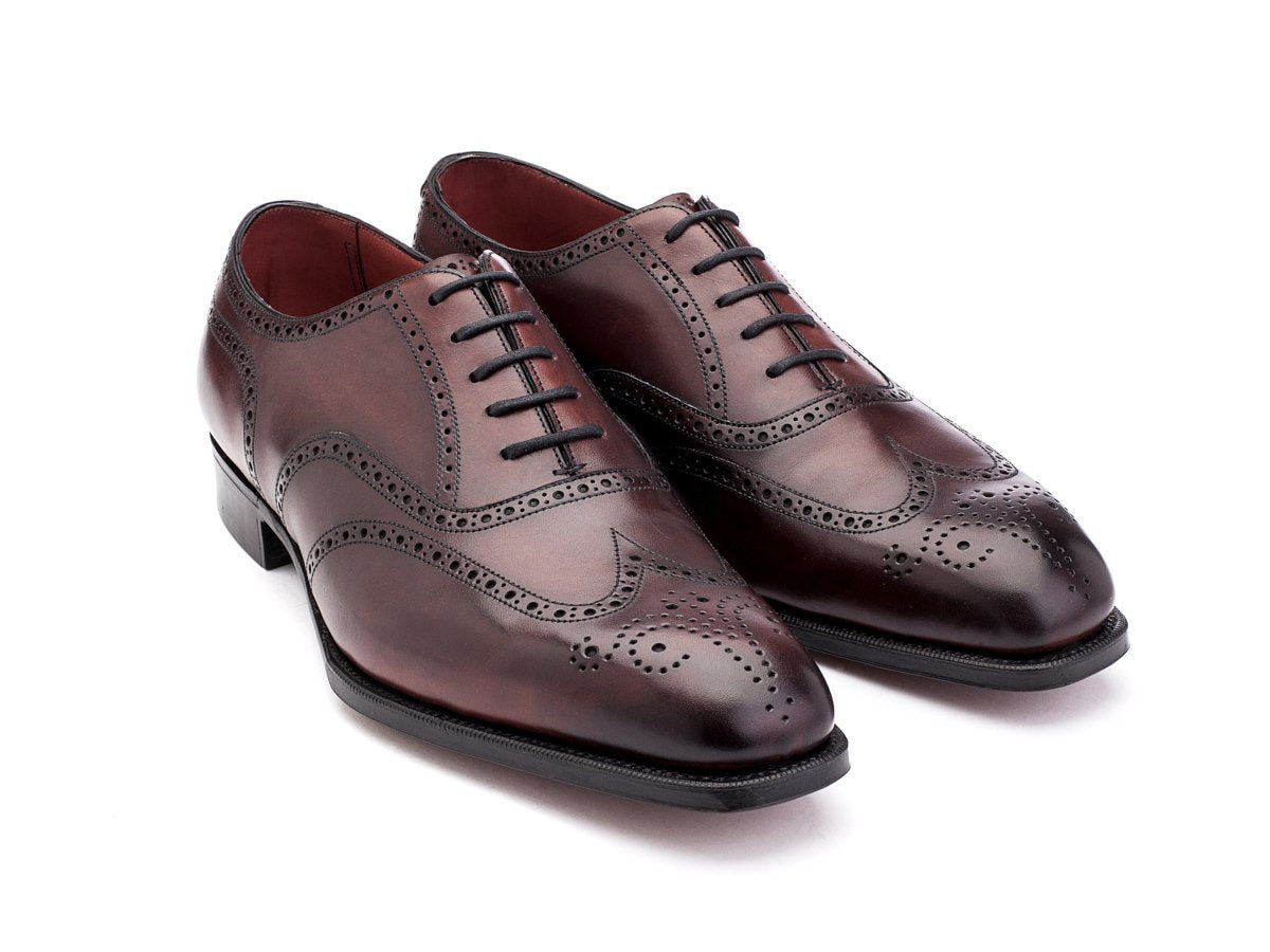 Front angle view of Edward Green Inverness wingtip full brogue oxford shoes in burgundy antique calf