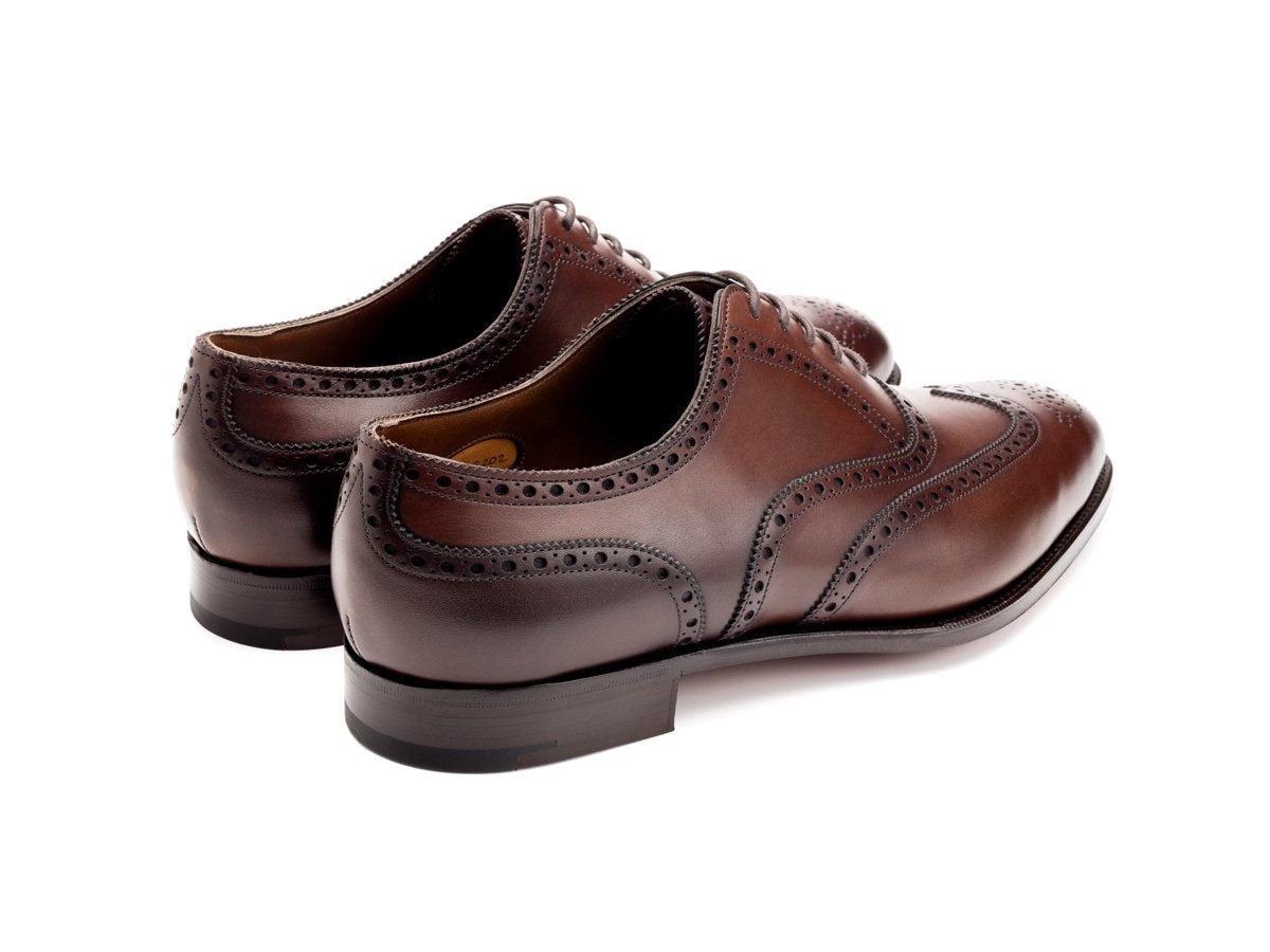 Back angle view of Edward Green Malvern wingtip full brogue oxford shoes in dark oak antique calf