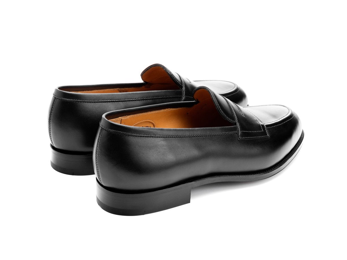 Back angle view of Edward Green Piccadilly penny loafers in black calf