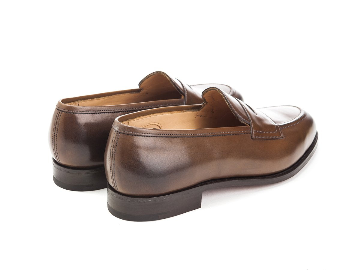 Back angle view of Edward Green Piccadilly penny loafers in dark oak antique calf