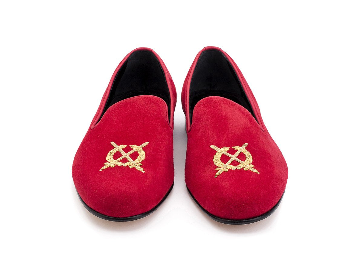 Front view of F width Edward Green Royal Albert slippers in scarlet suede with hand embroidered gold wreath and swords crest on toe