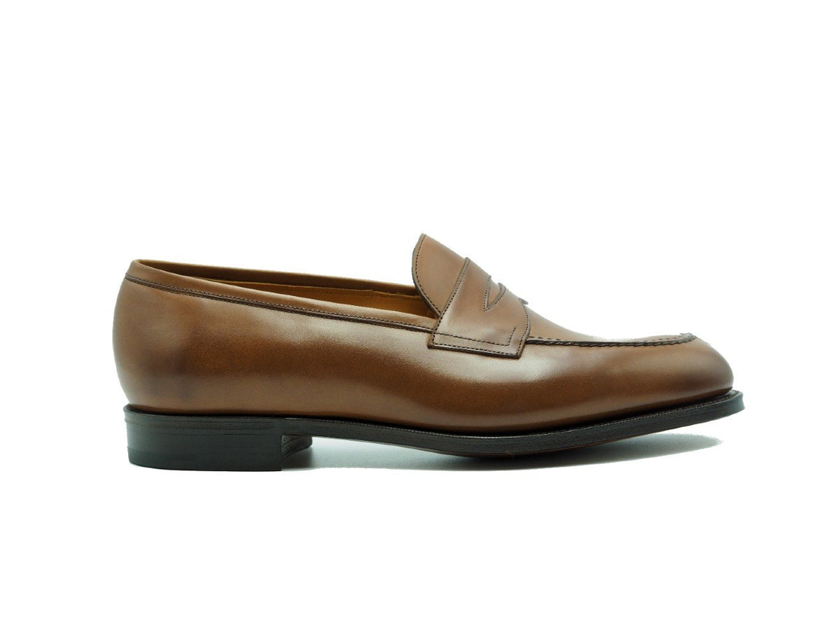 Side view of Edward Green Sloane split toe penny loafers in burnt pine antique calf