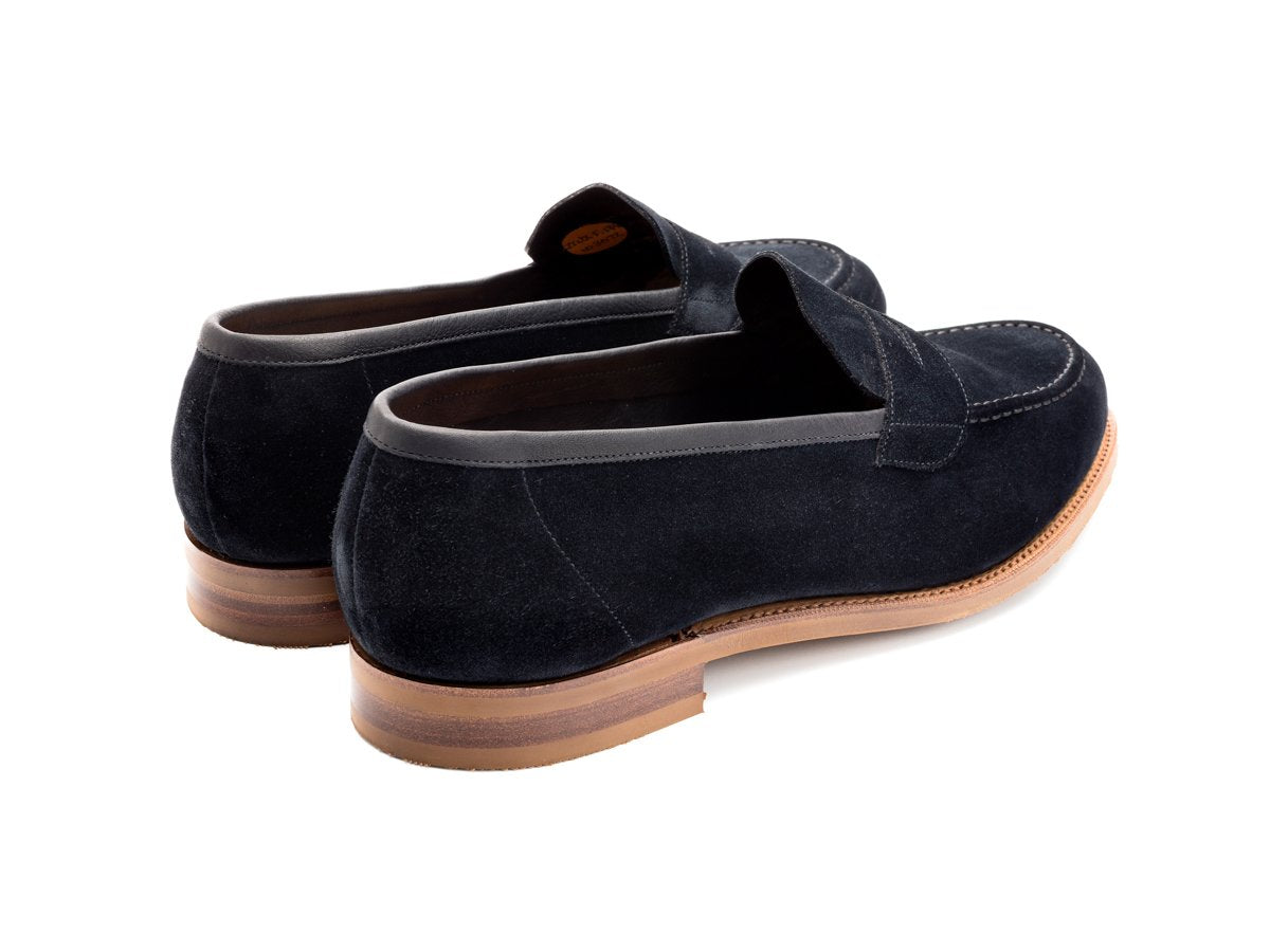 Back angle view of Edward Green Ventnor penny loafers in navy suede