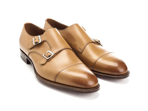 Front angle view of Edward Green Westminster plain captoe double monk strap shoes in acorn antique calf