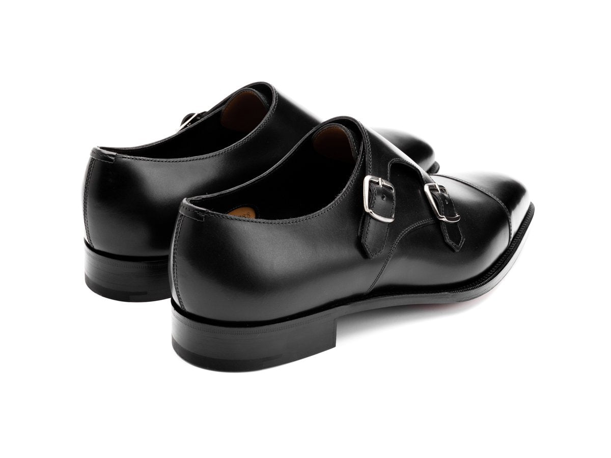 Back angle view of Edward Green Westminster plain captoe double monk strap shoes in black calf