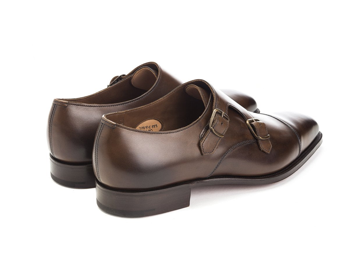 Back angle view of Edward Green Westminster plain captoe double monk strap shoes in dark oak antique calf