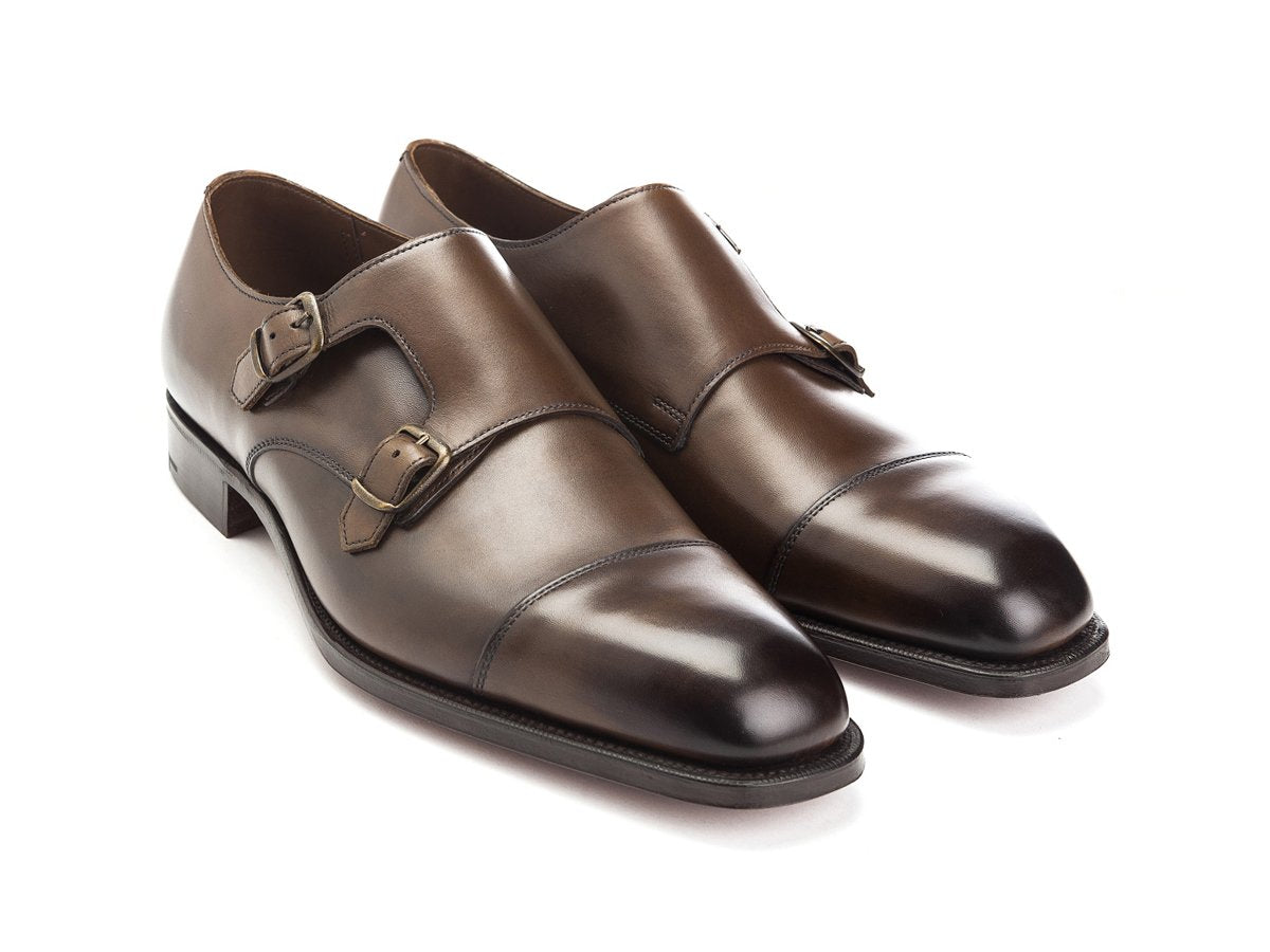 Front angle view of Edward Green Westminster plain captoe double monk strap shoes in dark oak antique calf