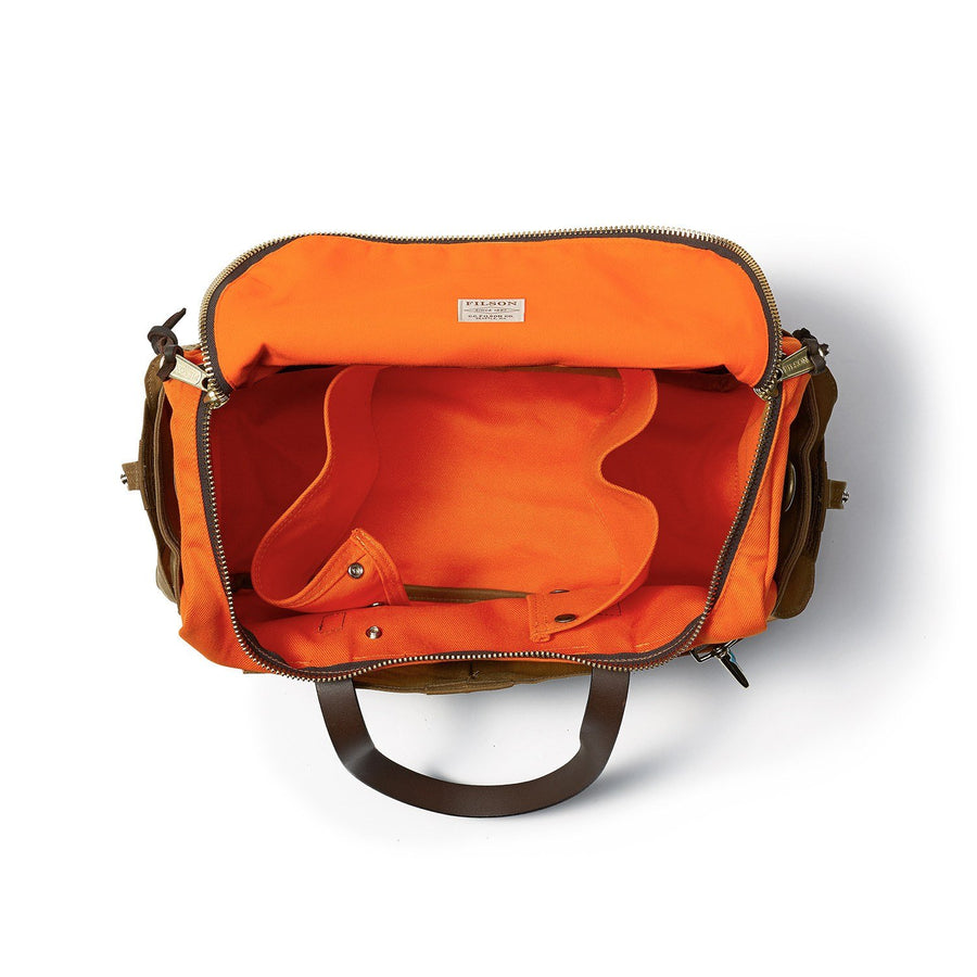 Top view of unzipped Filson Heritage Sportsman bag in orange and dark tan