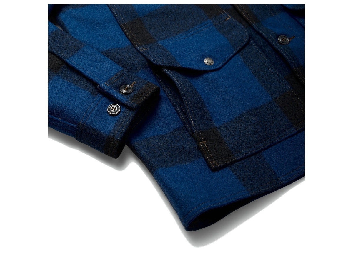 Close up view of Filson Mackinaw Cruiser jacket waist pocket in cobalt blue and black