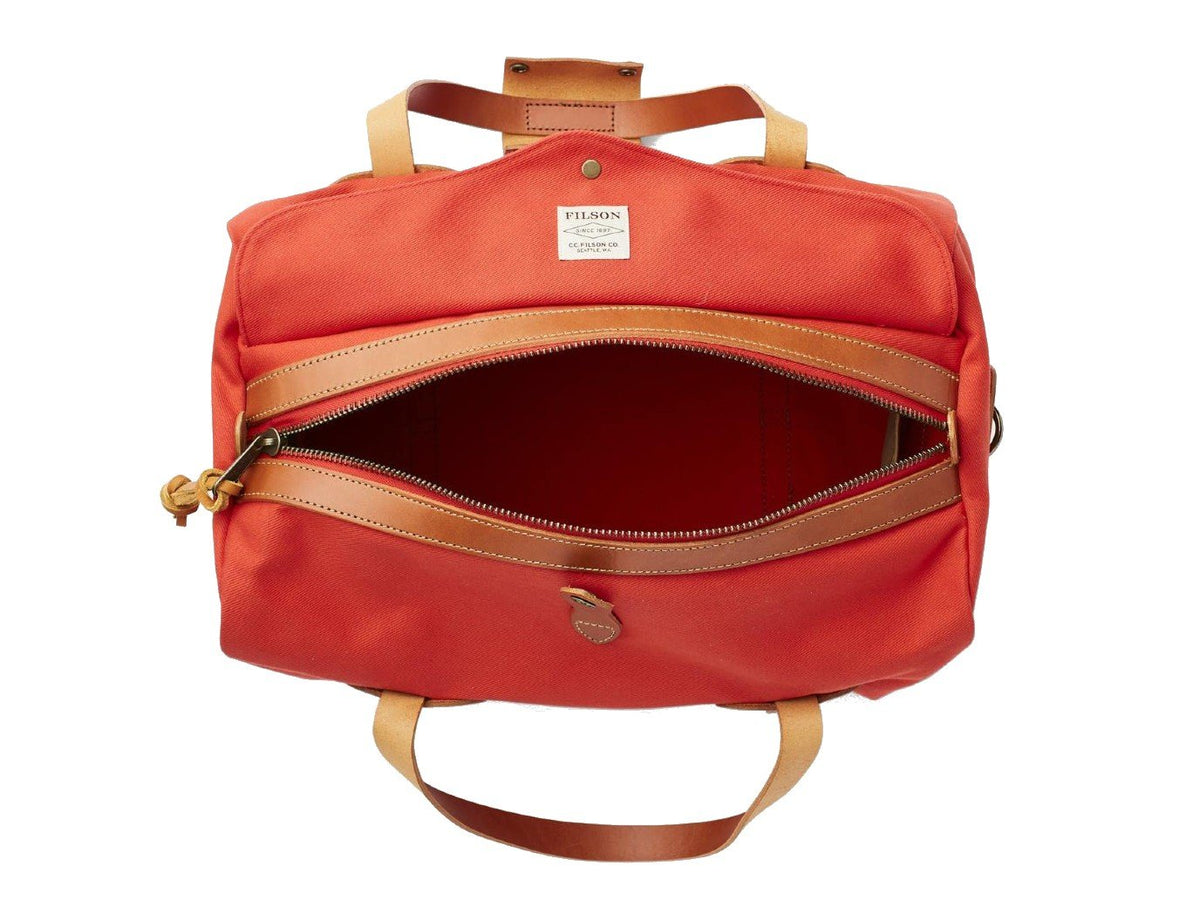 Top view of unzipped Filson Small Duffle bag in mackinaw red