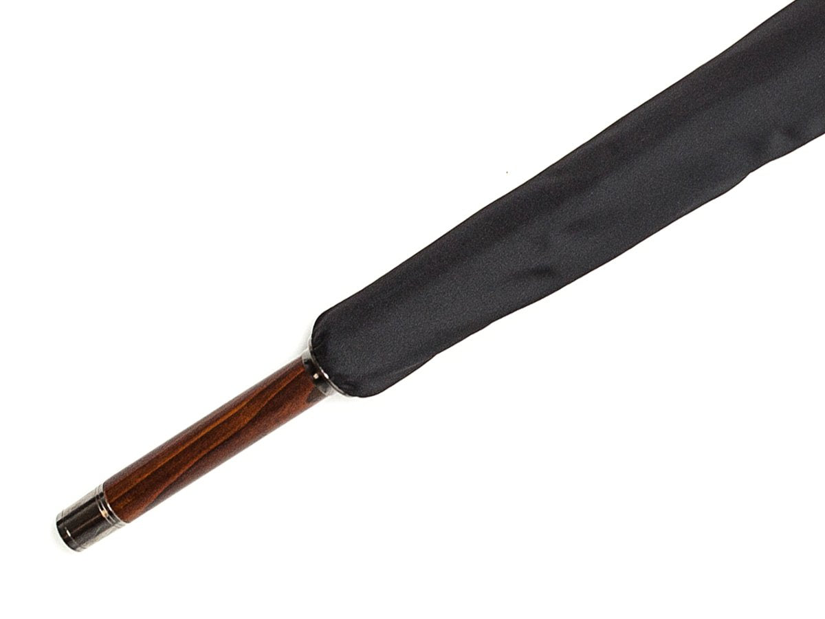 Tip end of solid polished cherrywood Fox Umbrella with black canopy