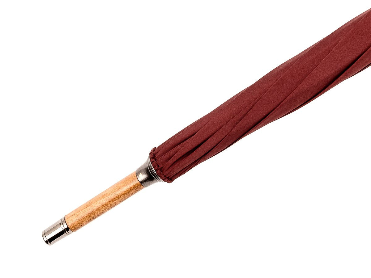 Tip end of solid scorched maple Fox Umbrella with burgundy canopy