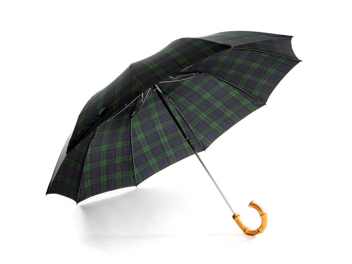 Opened whangee handle telescopic Fox Umbrella with black watch tartan canopy