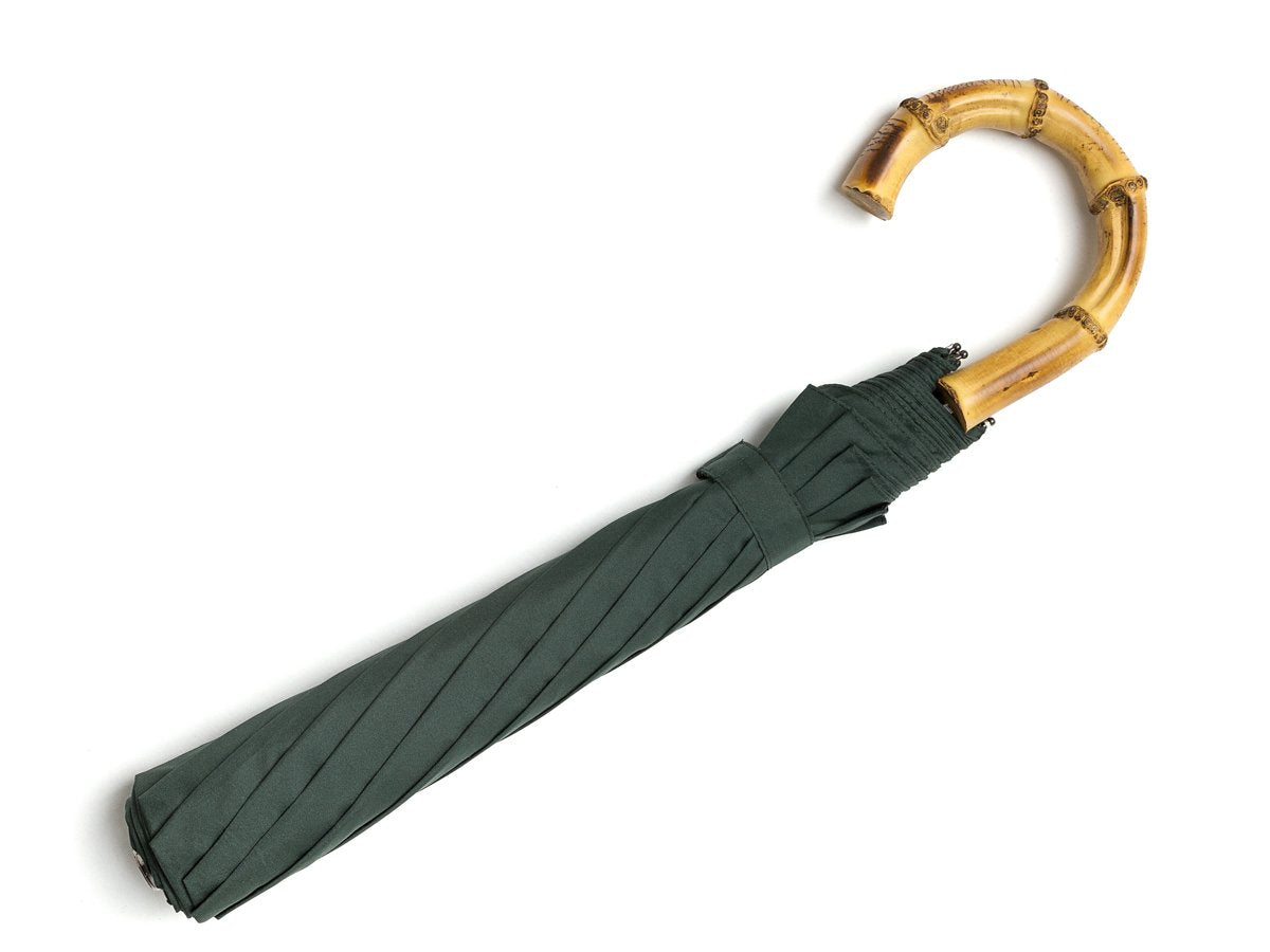 Full length view of whangee handle telescopic Fox Umbrella with dark green canopy