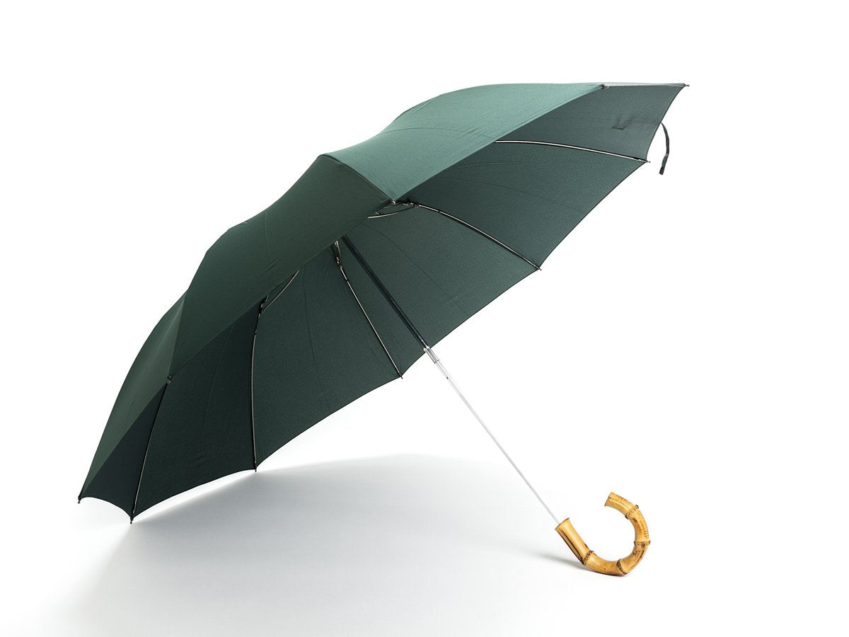 Opened whangee handle telescopic Fox Umbrella with dark green canopy