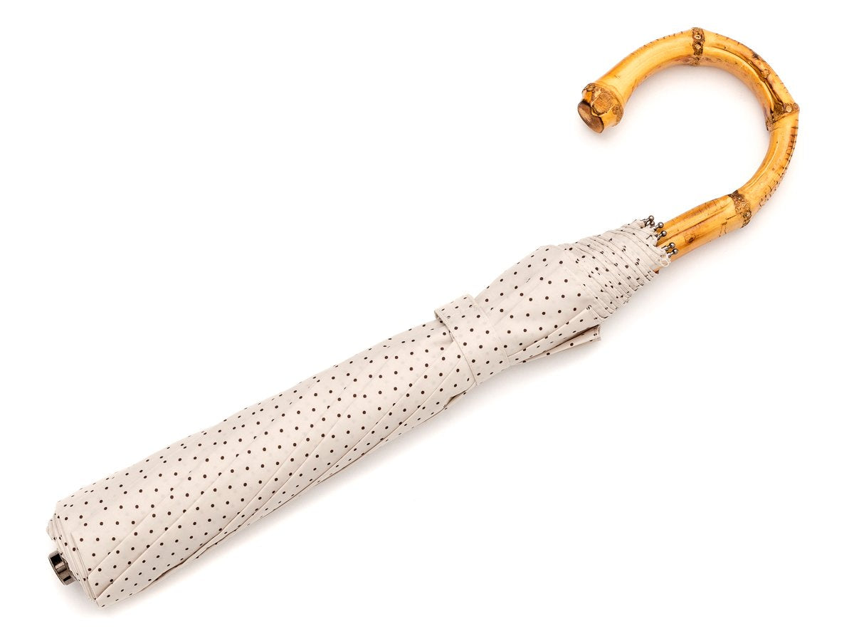 Full length view of whangee handle telescopic Fox Umbrella with ivory and brown polka dot canopy