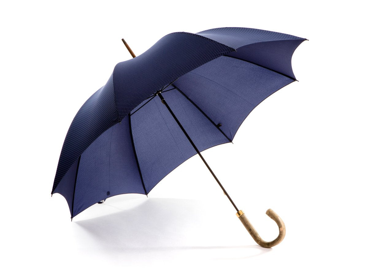 Opened ash handle tube Fox Umbrella with navy and white polka dot canopy