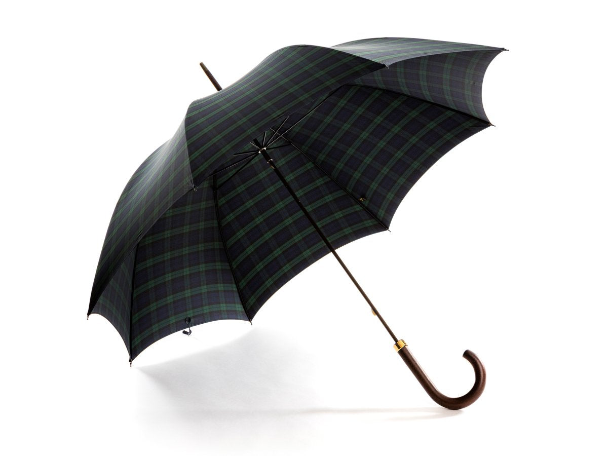 Opened dark brown wood handle tube Fox Umbrella with black watch tartan canopy