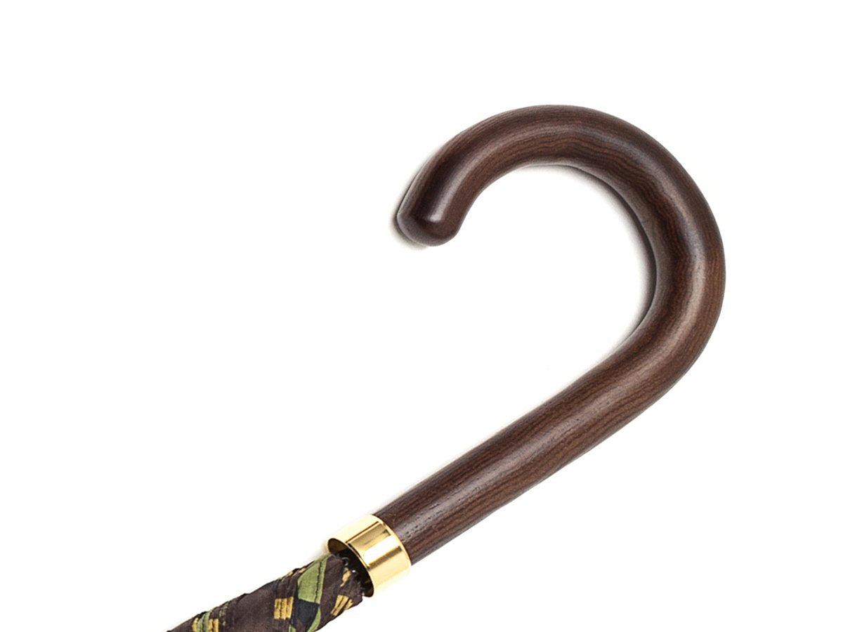 Dark brown wood handle of tube Fox Umbrella with camouflage canopy